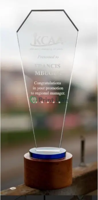 Long glass award with a round wooden base. 28*10cm PLAW067